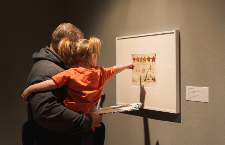 A child points to a peice at UW art museum