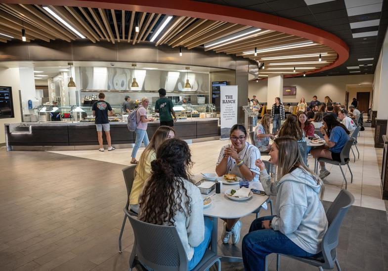 students eat a meal in the dining center