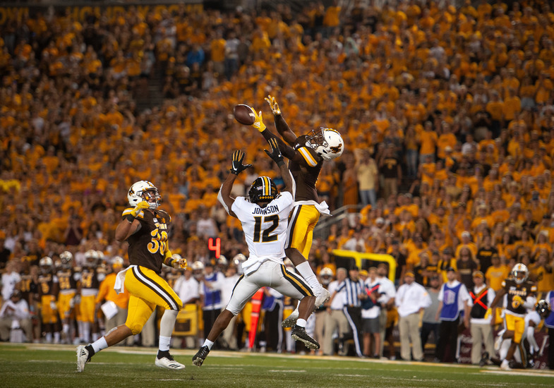 wyoming jumps to reach the football in a cowboys game