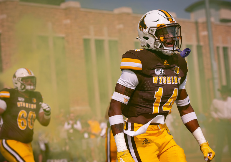 cowboys charge onto the feild in a gold smoke 