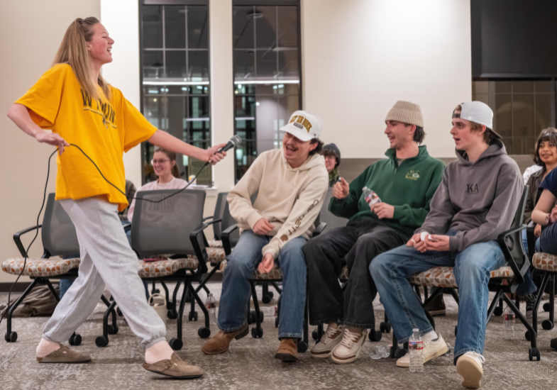 Smiling student reading in library