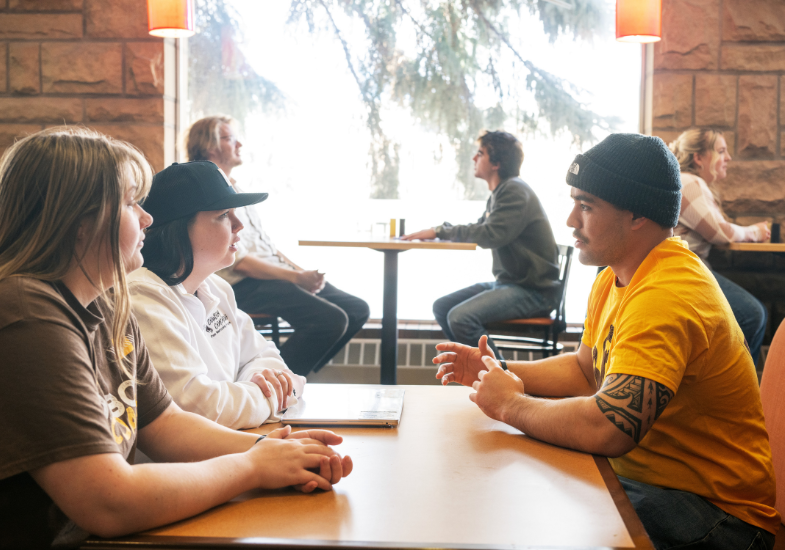 student chatting with a cowboy coach