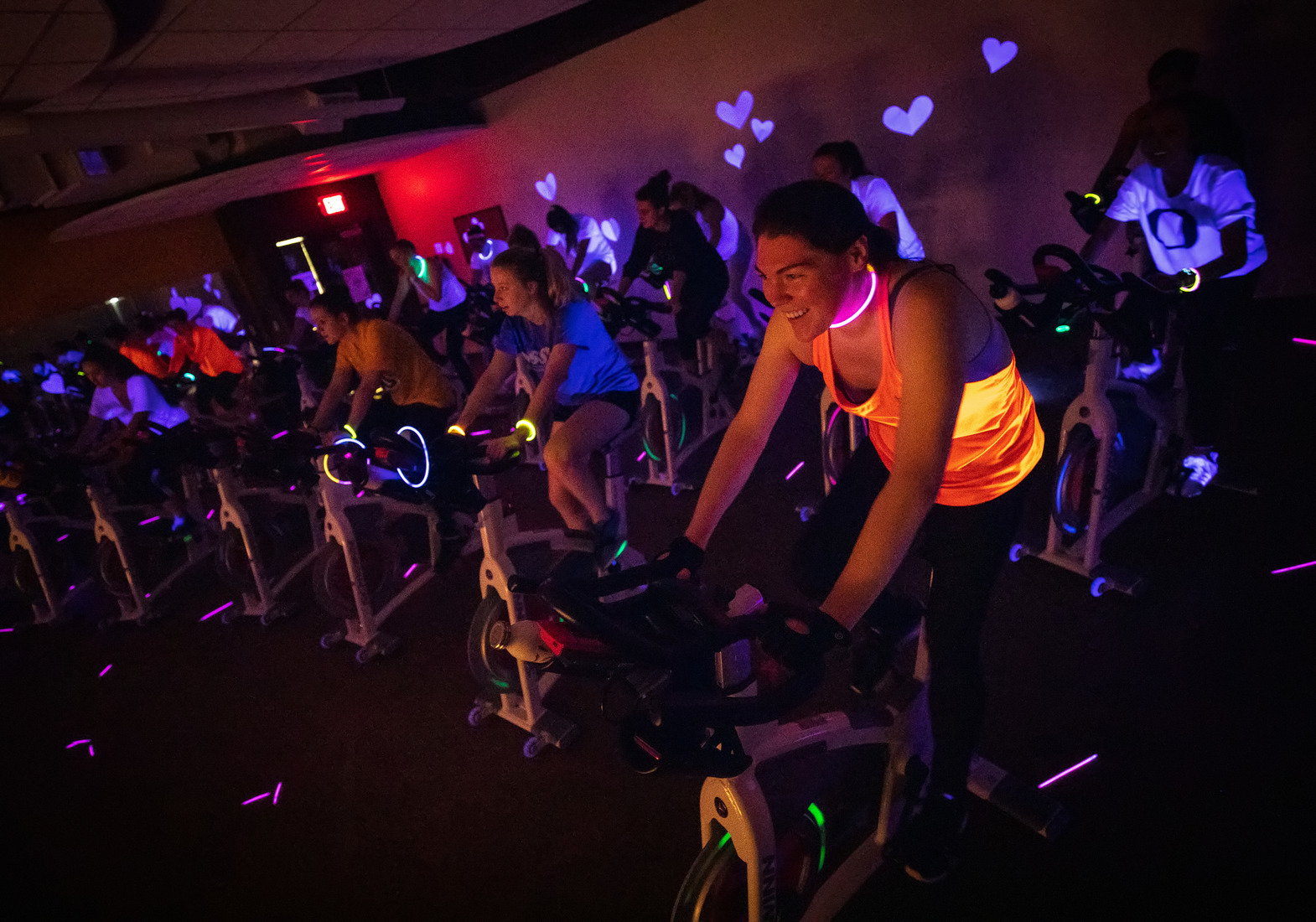 Students in a glow cycle class