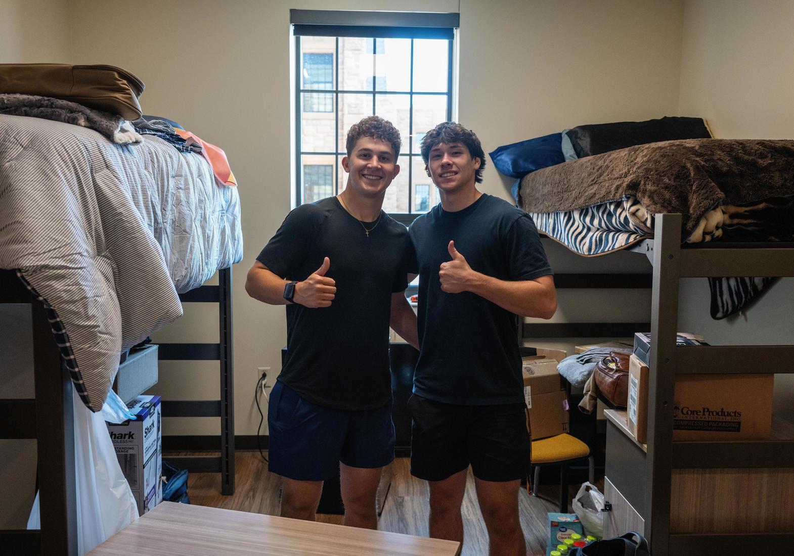Roommates give a thumbs up on move-in day