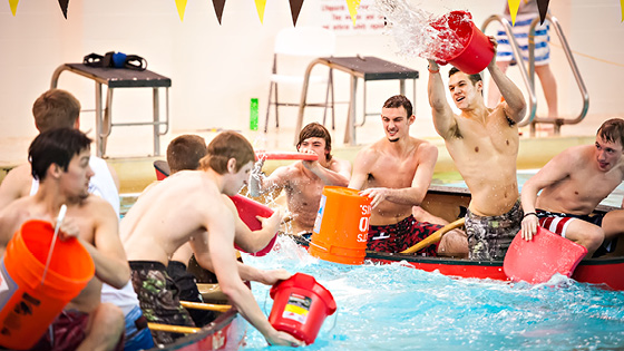 A group of Students in Corbett pool playing Battle Ship in canoes