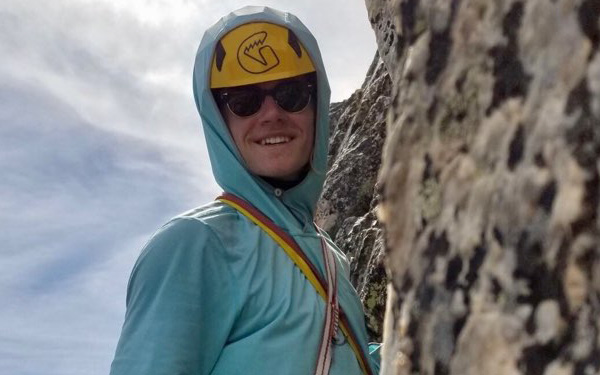 Lasko smiling on side of cliff