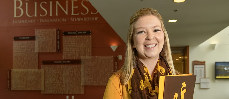 Student standing in the Business Building 