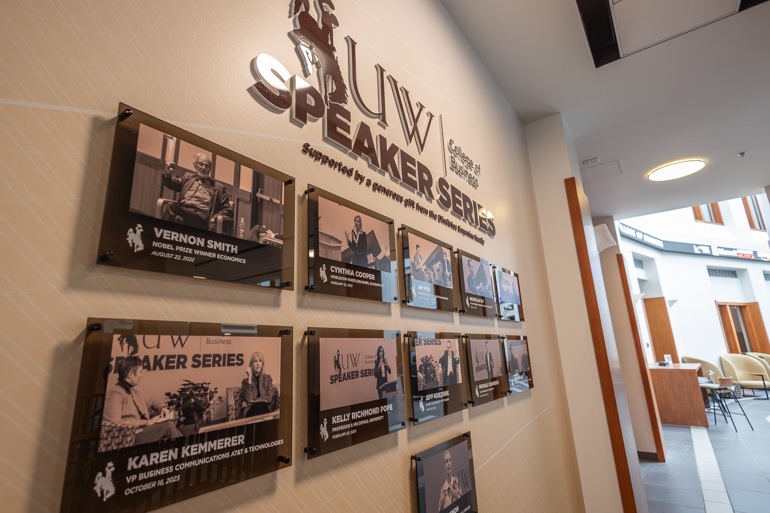 Picutre of the speaker series wall in the college of business