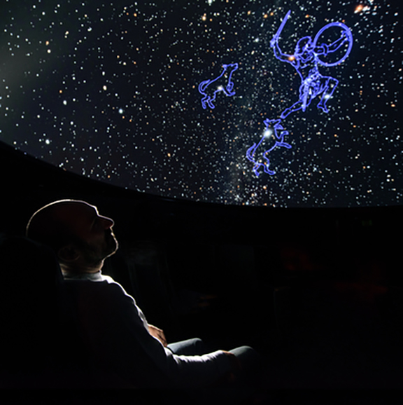 man looks at stars