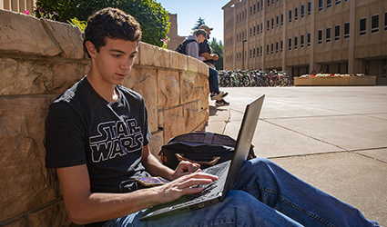 student looks at laptop