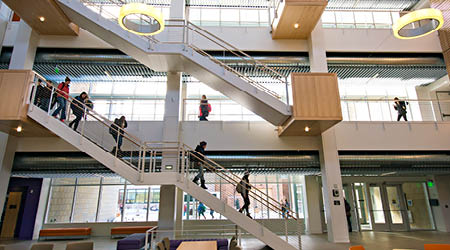 A double set of stair cases are pictured inside the Enzi STEM center