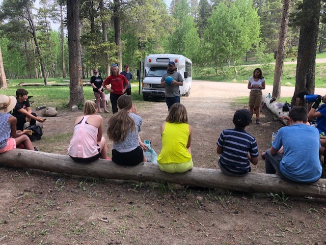 An engineer talks to campers about maps