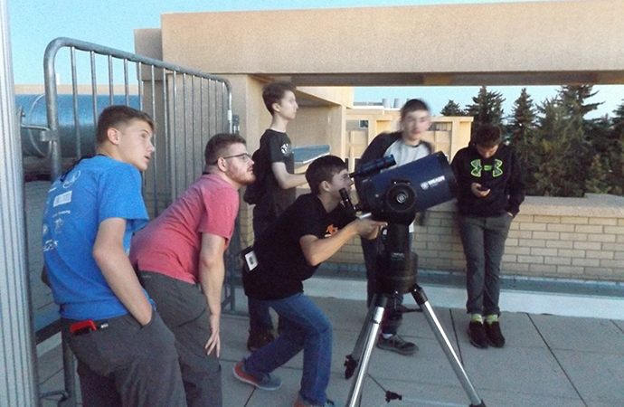 group looks through telescope