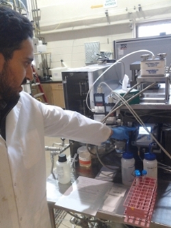 A PhD candidate, Mahdi, checking the pH and conductivity of a sample.