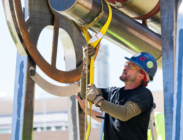 Student working outside on a large machine