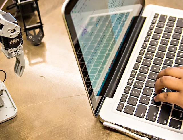 Hand typing on laptop
