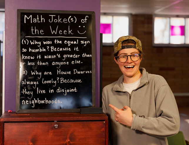 Math joke of the week with student pointing to chalkboard