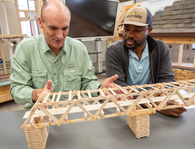 Teacher and student working on a bridge