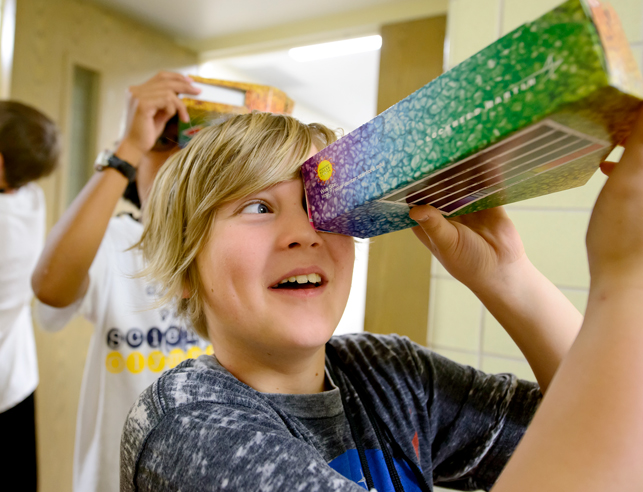 Student looking inside a box
