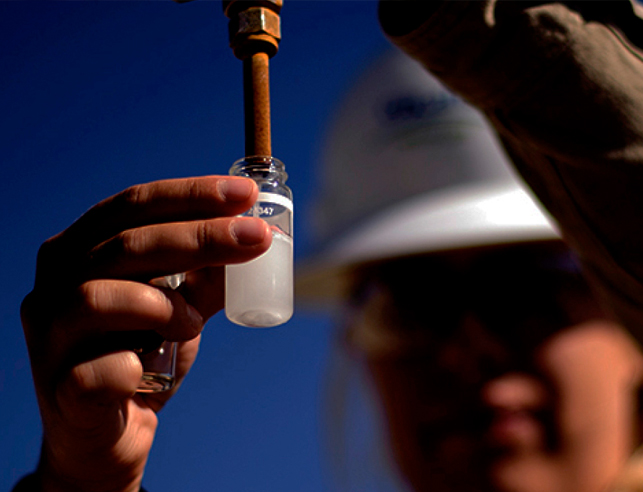 Engineer holding liquid specimen