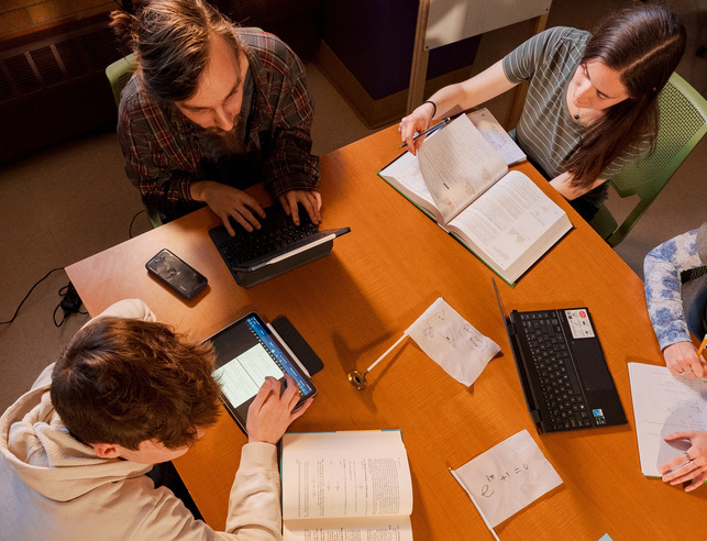 Faculty working with a group of students