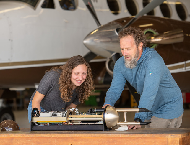 Jeff with student in front of plane