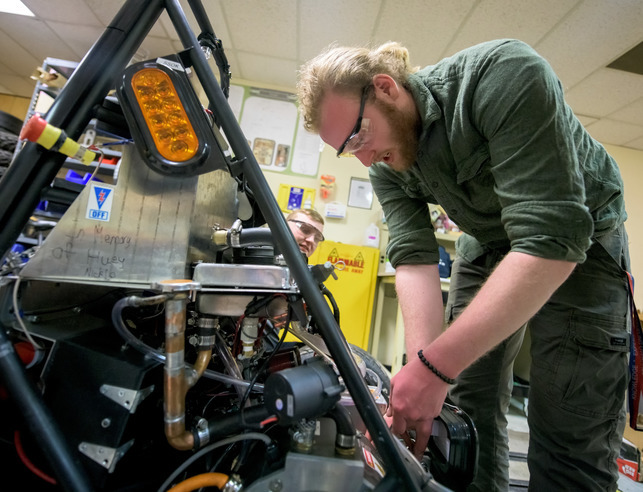 Student working on large machine