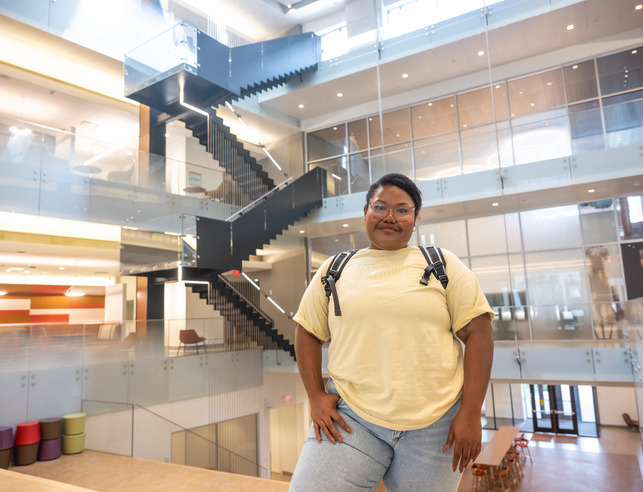 Student inside of EERB building with stairs in the background