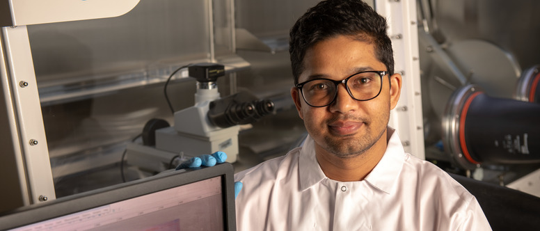Student smiling in a lab