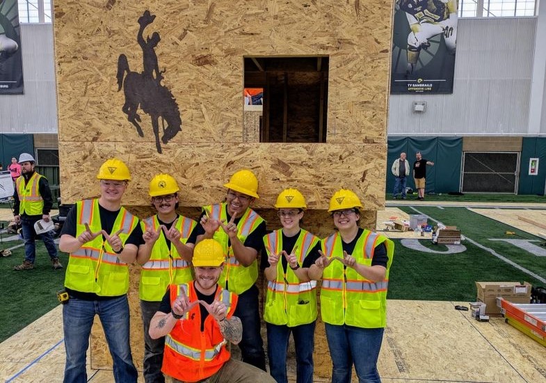 ASCE Conference 2025 group in front of saloon wall