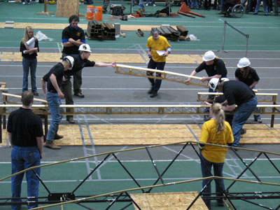 Students working on bridge competition - placing portions of the structure in place