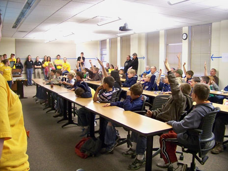 students raising hands