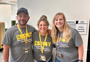 three teachers - one man and two women standing together in gray ESP4T t-shirts