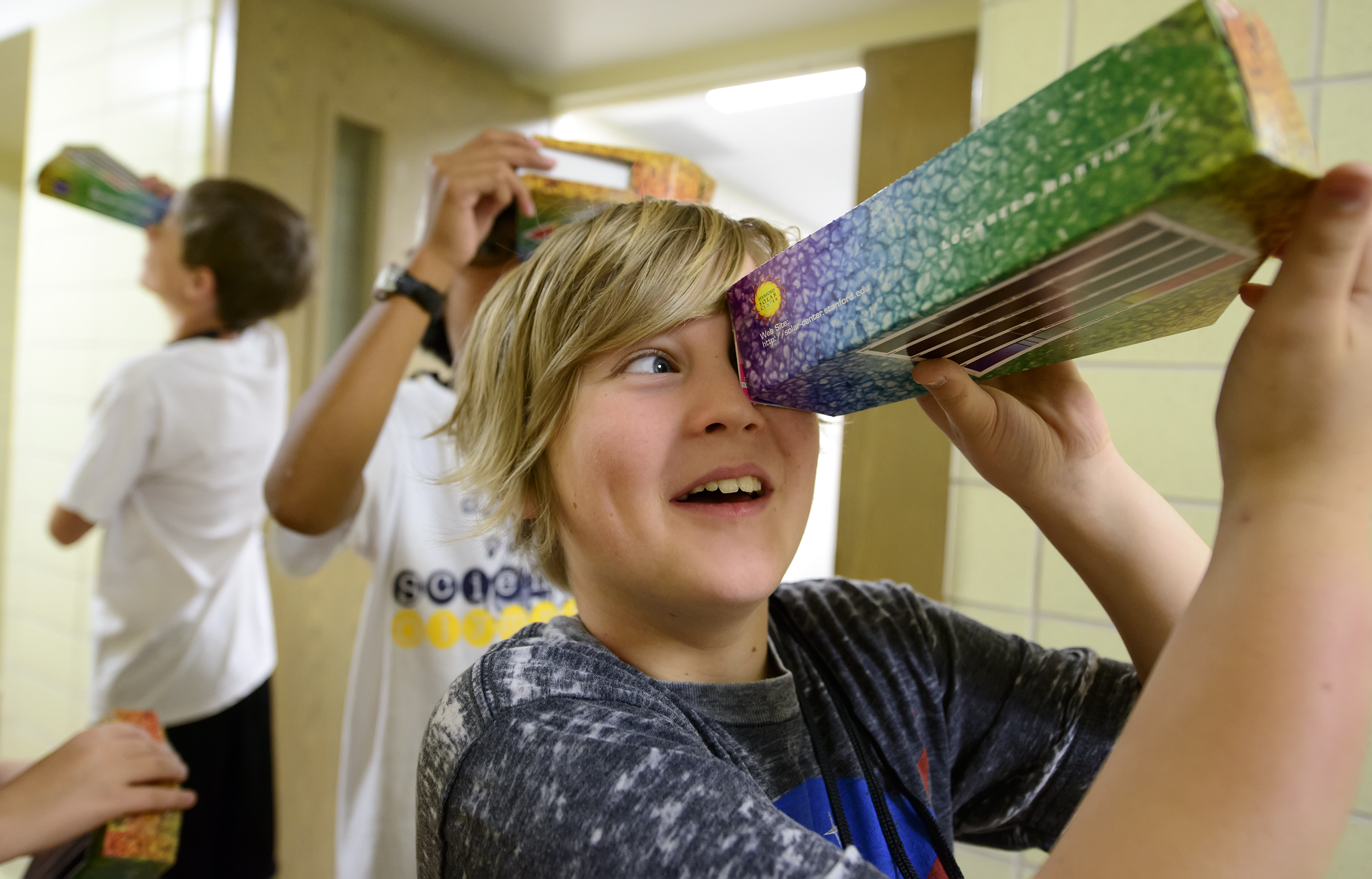 student looks through prism