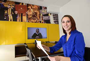 Female Smiling holding paper 