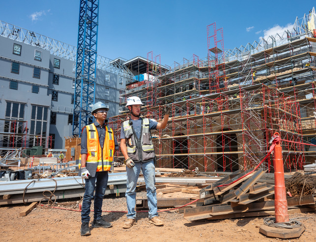 Civil Engineering major and international student (India), Darsh Patel, gets a tour of the North and South Residence Halls construction site. The new halls are slated to open in the fall of 2025. 