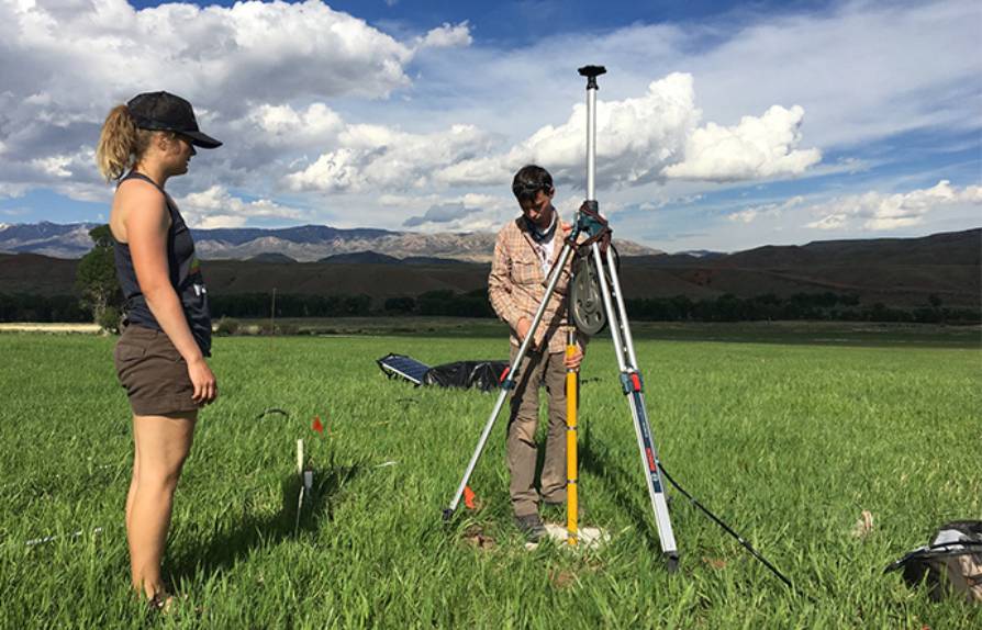 Civil engineering students test groundwater using meters.