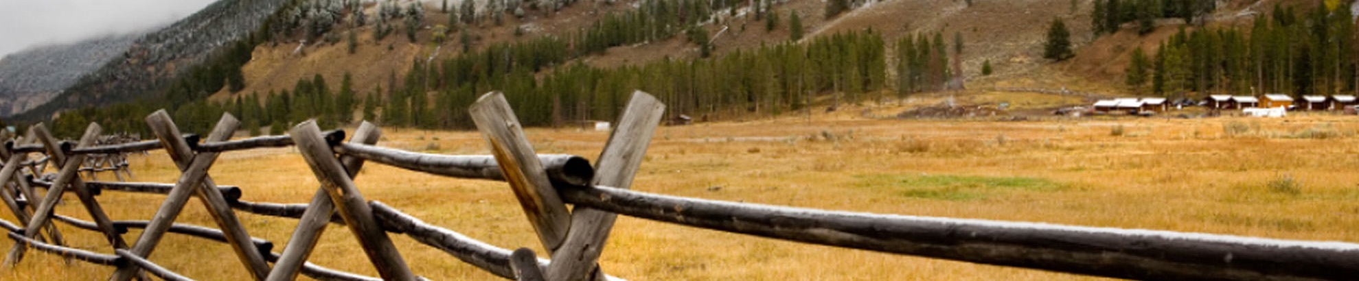 Fence in field with mountains in background