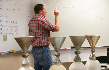 Shawn teaching with lab equipment in foreground