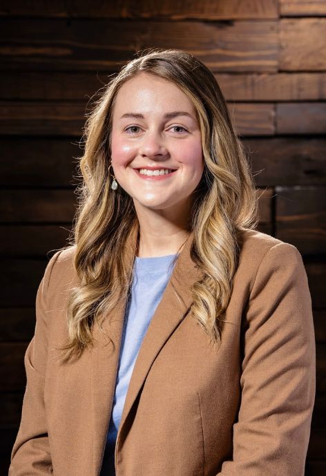 Olivia Smith in front of a brick wall