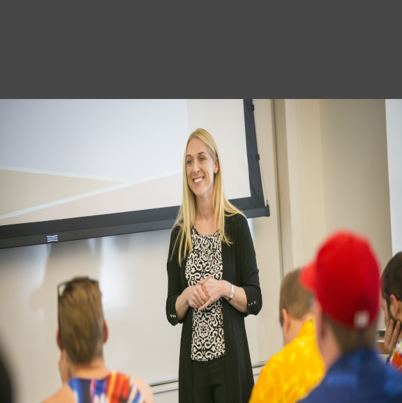 Teacher standing at the front of a classroom 