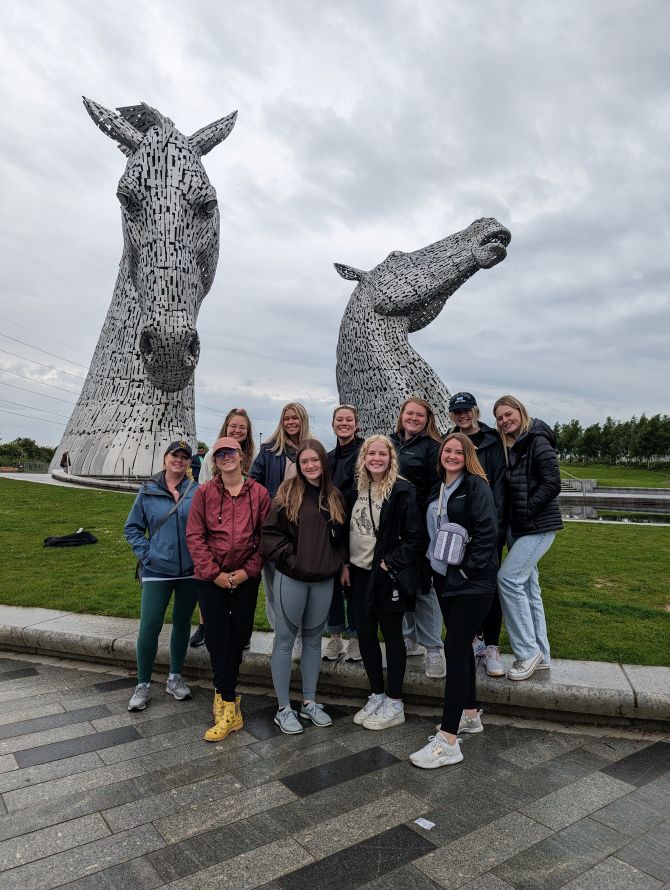 students standing in front of two horse head sculptures in Scotland