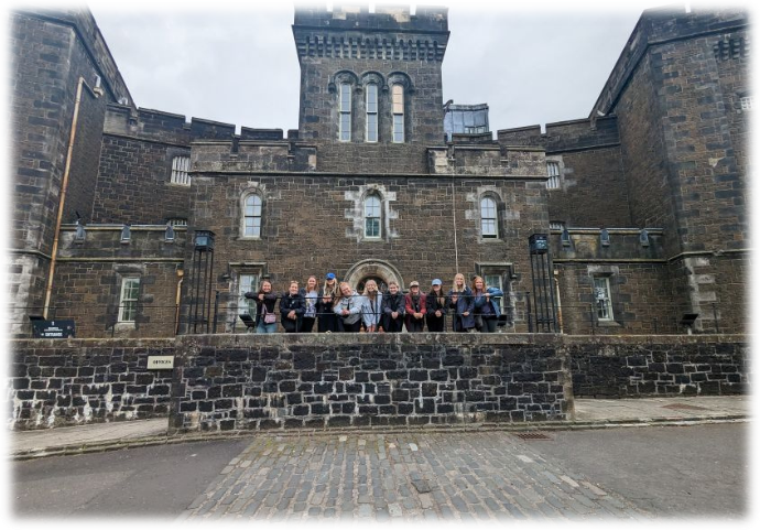 Students stand in front of historic prison in Scotland