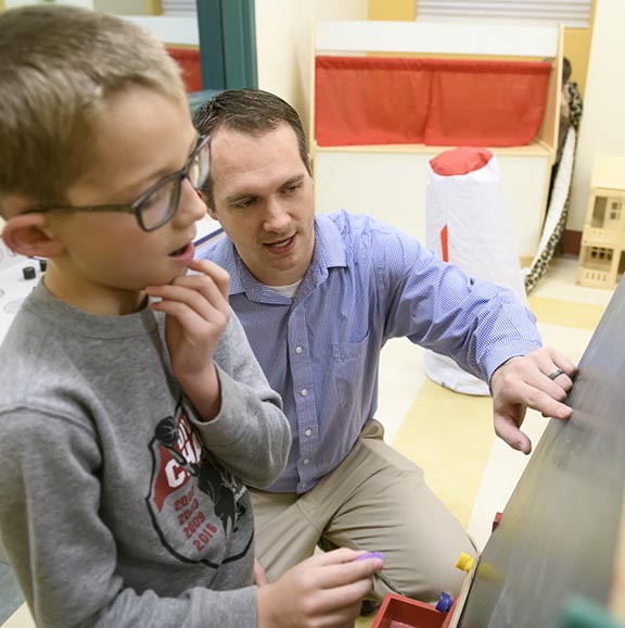 man working with a child