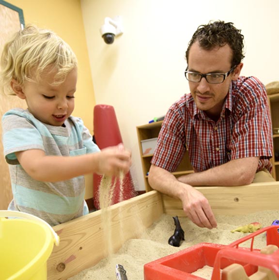 Counselor playing with child in the clinic.