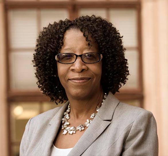 female student in a suit smiling