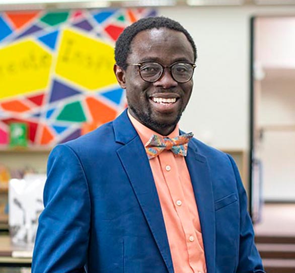 male student in a suit smiling