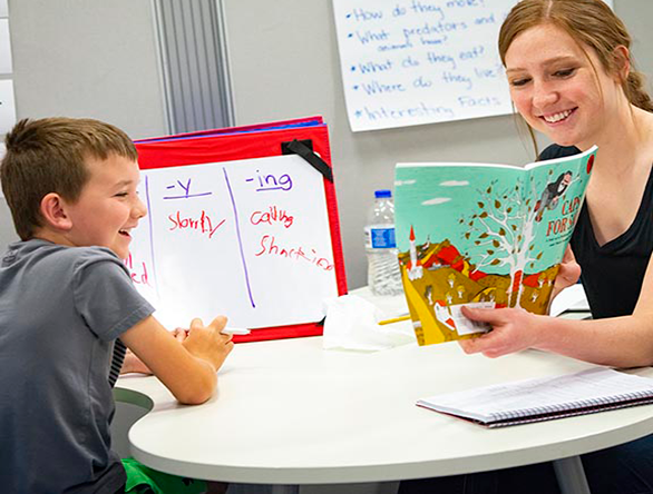 A student reads to a tutoring student