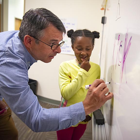 teacher working with student