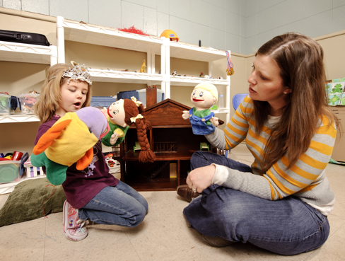 student practicing play therapy
